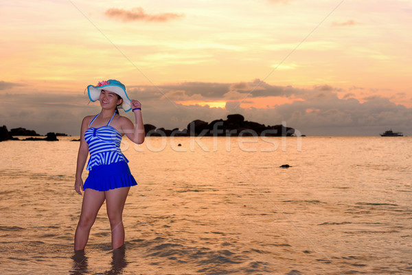 Girl on the beach at sunrise over the sea Stock photo © Yongkiet