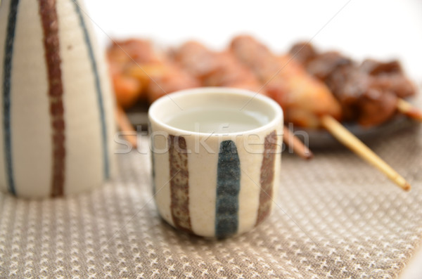 Japanese SAKE cup with char-broiled chicken yakitori Stock photo © YUGOKYOGO