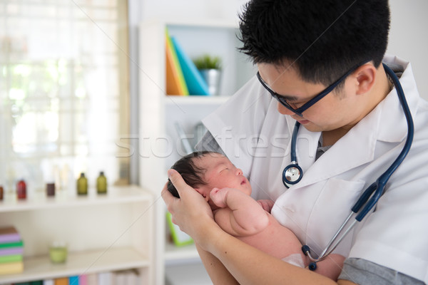 asian male doctor and newborn baby on the clinic Stock photo © yuliang11