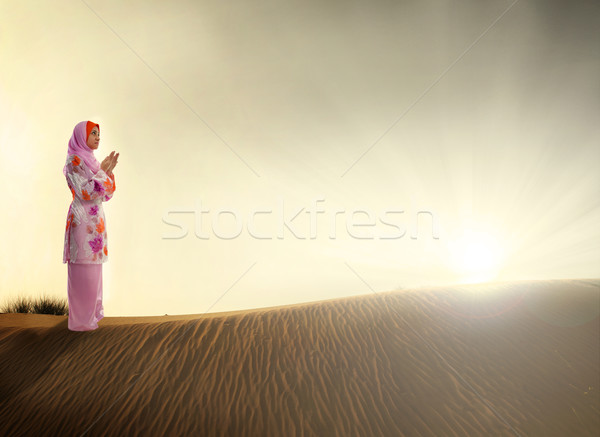 muslim woman praying on the desert Stock photo © yuliang11