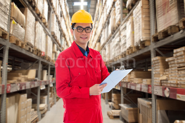 asian chinese male working on a ware house doing stock tick Stock photo © yuliang11