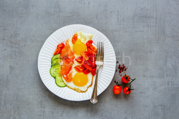 Breakfast with salmon and fried eggs Stock photo © YuliyaGontar