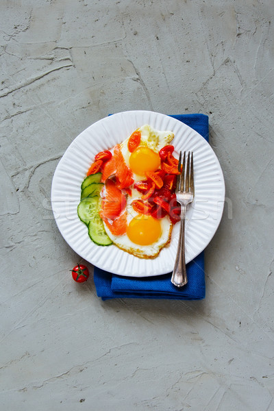 Breakfast with salmon and fried eggs Stock photo © YuliyaGontar