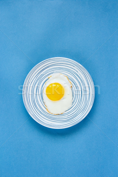 Fried egg in plate Stock photo © YuliyaGontar