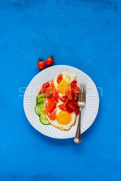 Breakfast with salmon and fried eggs Stock photo © YuliyaGontar