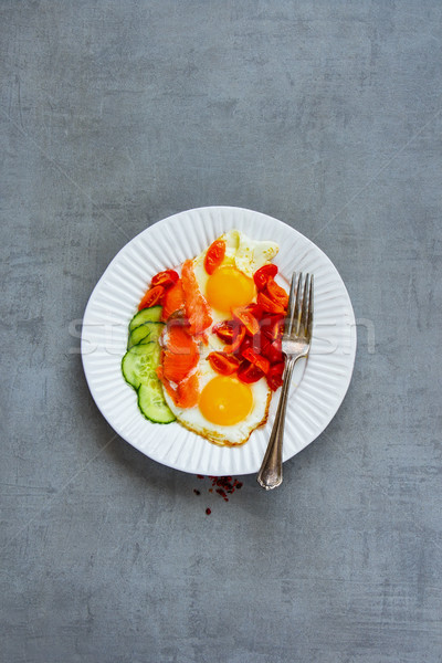 Breakfast with salmon and fried eggs Stock photo © YuliyaGontar