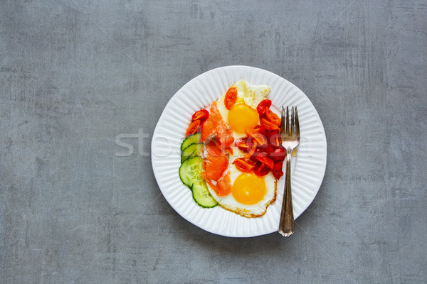 Breakfast with salmon and fried eggs Stock photo © YuliyaGontar