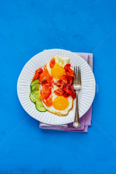 Breakfast with salmon and fried eggs Stock photo © YuliyaGontar