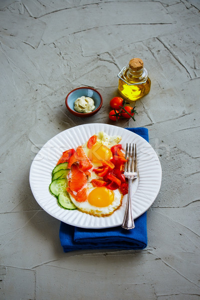 Breakfast with salmon and fried eggs Stock photo © YuliyaGontar