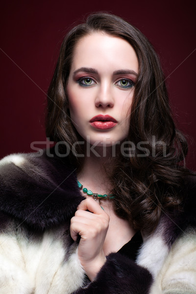 Young beautiful woman in fur coat and with green pistachio colou Stock photo © zastavkin