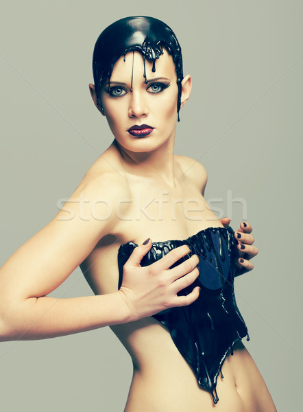 Stock photo: Woman in dress of molten vinyl disk