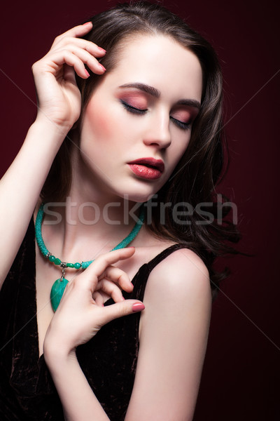 Young beautiful woman with closed eyes on red marsala background Stock photo © zastavkin