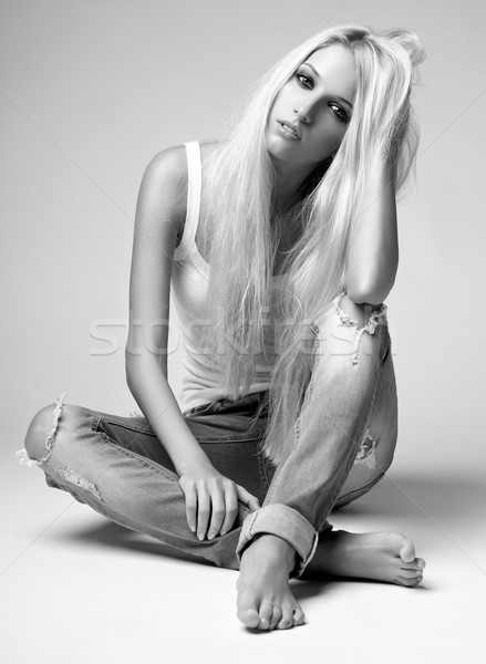 Blonde woman in ragged jeans and vest Stock photo © zastavkin
