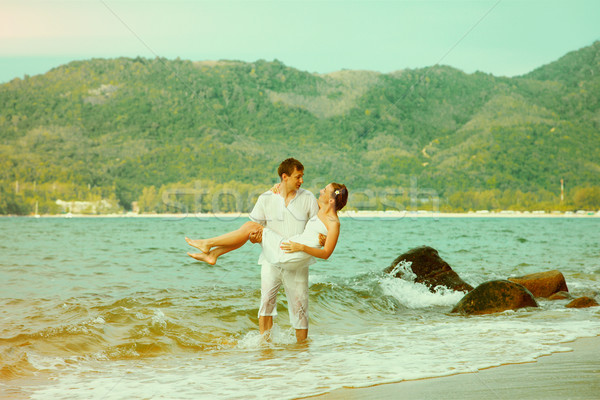 Instagram colorized vintage couple on beach portrait Stock photo © zastavkin