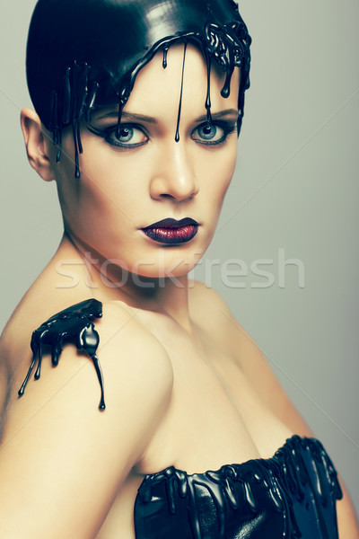 Woman in dress of molten vinyl disk Stock photo © zastavkin