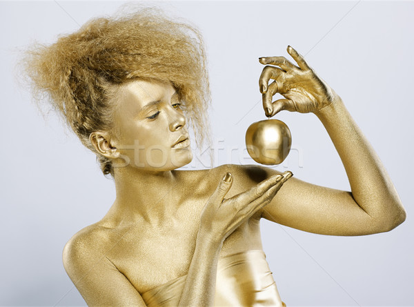 golden girl with apple Stock photo © zastavkin