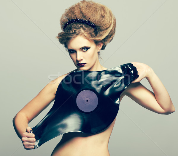 Stock photo: Woman in dress of molten vinyl disk