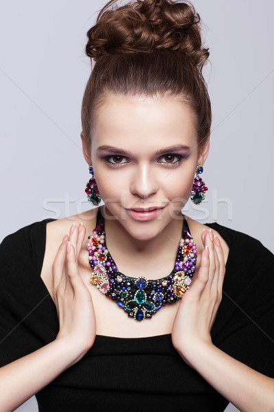 Młoda kobieta biżuteria szary czarna sukienka strony twarz Zdjęcia stock © zastavkin