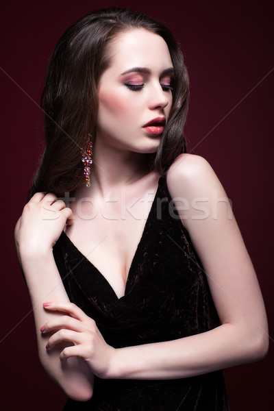 Young beautiful woman in black dress on red marsala background Stock photo © zastavkin