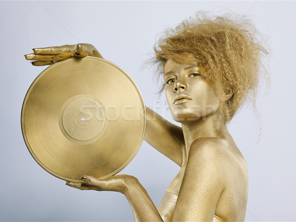 golden girl with vinyl Stock photo © zastavkin