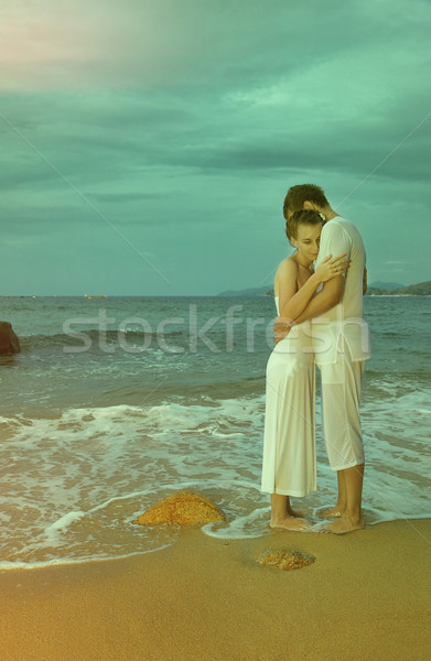 Instagram colorized vintage couple on beach portrait Stock photo © zastavkin