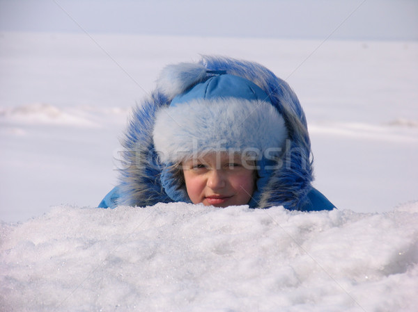 Young girl hiding after snowdrift  Stock photo © zastavkin