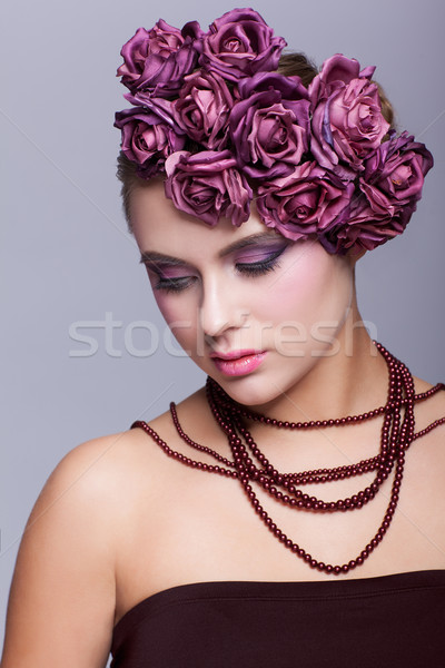 Stock photo: Beautiful young woman with artificial rouses on head necklace an