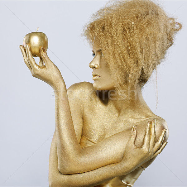 golden girl with apple Stock photo © zastavkin