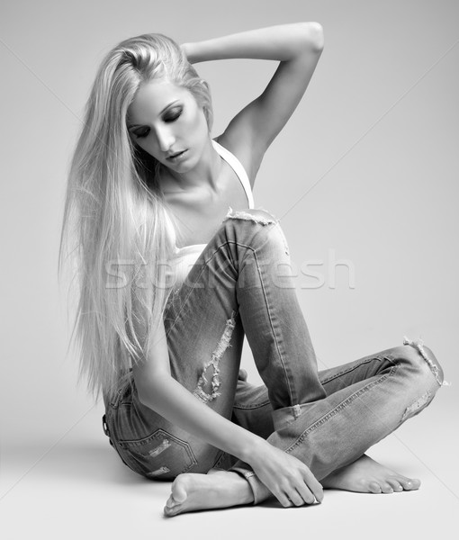Blonde woman in ragged jeans and vest Stock photo © zastavkin