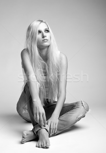 Blonde woman in ragged jeans and vest Stock photo © zastavkin