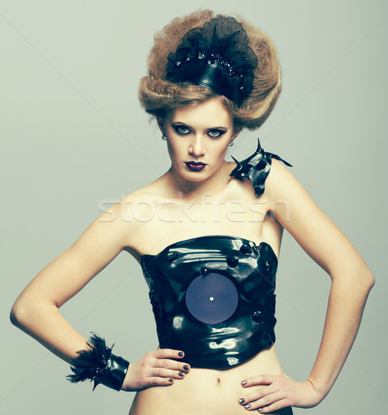 Woman in dress of molten vinyl disk Stock photo © zastavkin