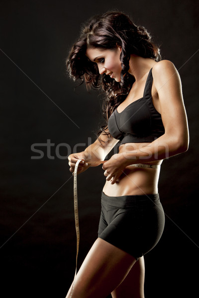 Fitnessz nő fitnessz modell barna hajú mér derék Stock fotó © zdenkam