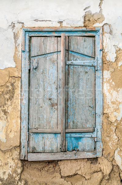 Old wooden window shutters on the background of the destroyed wa Stock photo © zeffss