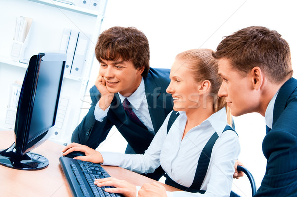 Three young successful businesspeople. Screen has a clipping pat Stock photo © zeffss