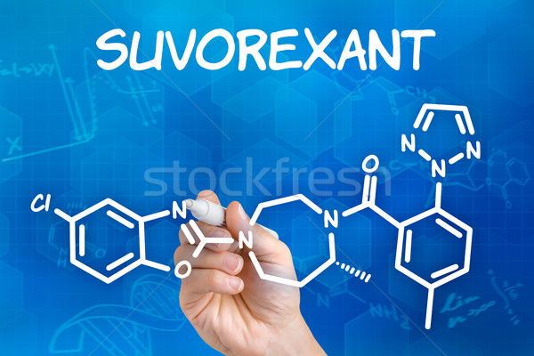 Hand with pen drawing the chemical formula of Suvorexant Stock photo © Zerbor