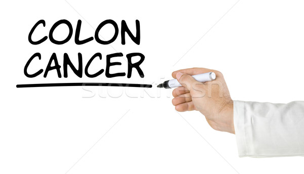 Stock photo: Hand with pen writing Colon Cancer