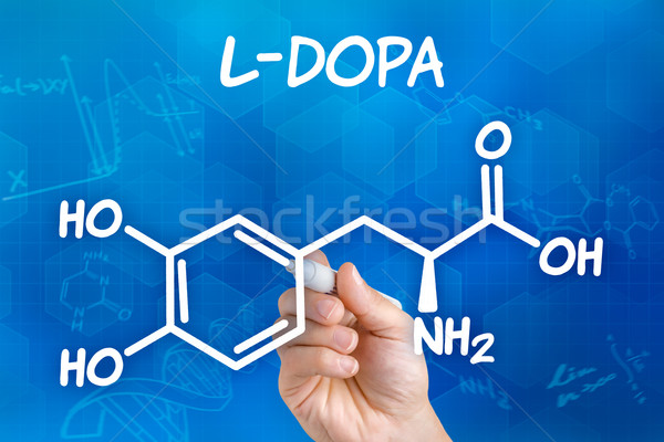 Stock photo: Hand with pen drawing the chemical formula of L-DOPA