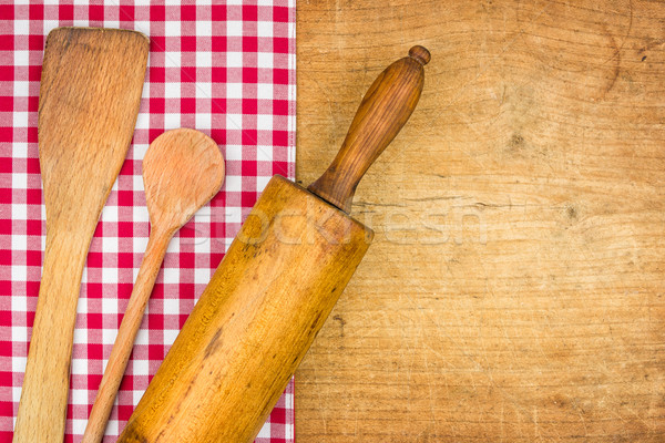 Rolling pin with wooden spoon on a wooden board with a checkered tablecloth Stock photo © Zerbor
