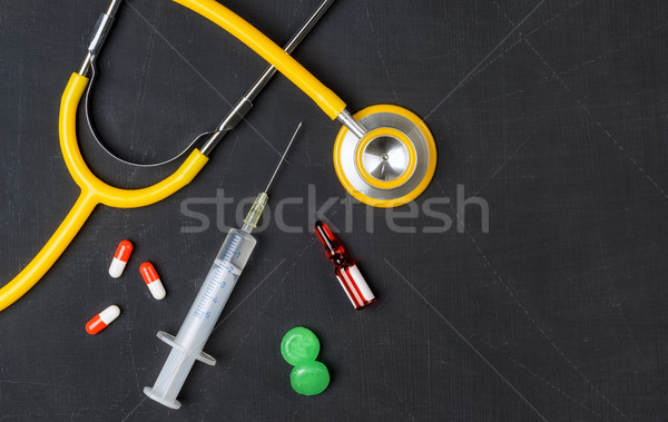 Stethoscope and pharmaceuticals on a chalkboard Stock photo © Zerbor