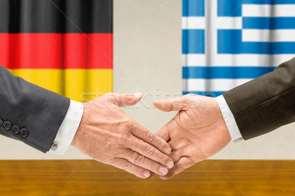 Representatives of Germany and Greece shake hands Stock photo © Zerbor