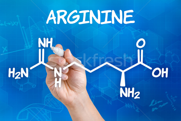 Hand with pen drawing the chemical formula of arginine Stock photo © Zerbor