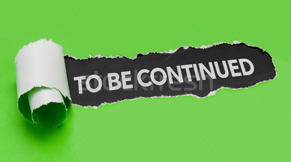 Stock photo: Torn green paper revealing the words to be continued