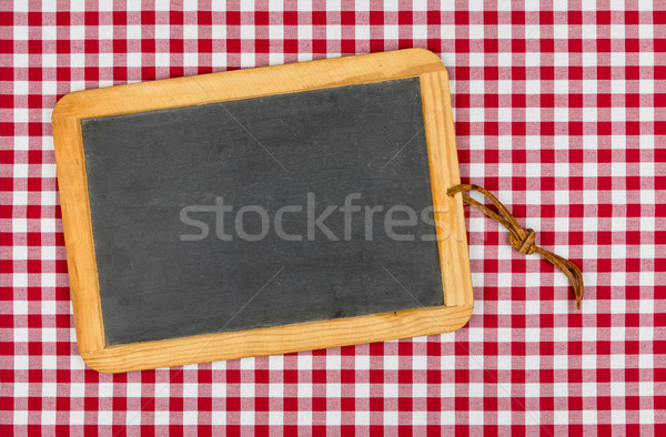 Empty blackboard with chalk on a red checkered table cloth Stock photo © Zerbor