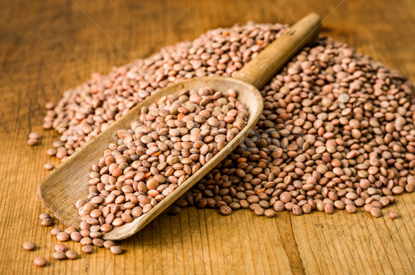 Wooden scoop with brown lentils Stock photo © Zerbor