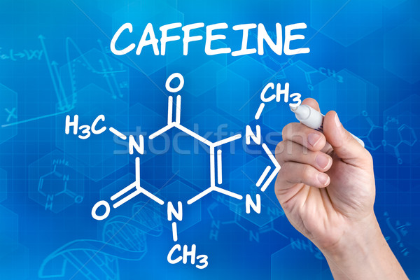 hand with pen drawing the chemical formula of Caffeine Stock photo © Zerbor