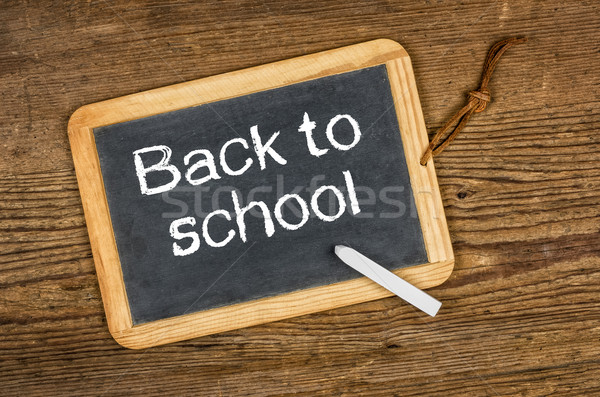 Blackboard with the text Back to school on a wooden table Stock photo © Zerbor