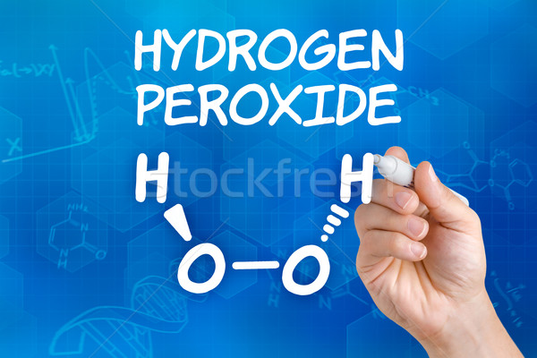 Hand with pen drawing the chemical formula of hydrogen peroxide Stock photo © Zerbor