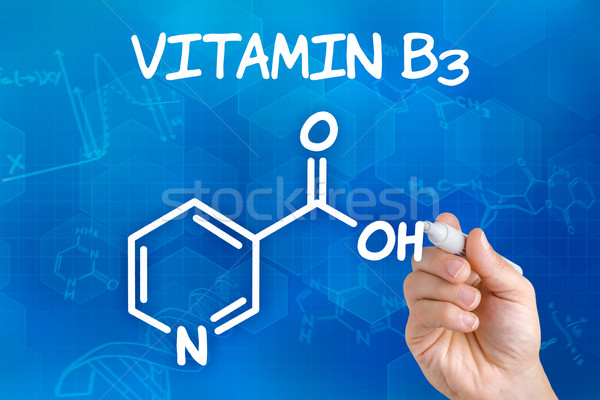 Hand with pen drawing the chemical formula of Vitamin B3 Stock photo © Zerbor