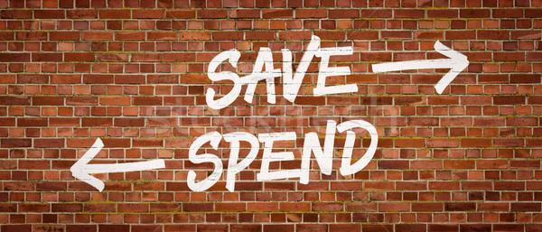 Save or Spend written on a brick wall Stock photo © Zerbor