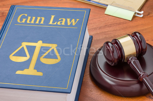 A law book with a gavel - Gun law Stock photo © Zerbor